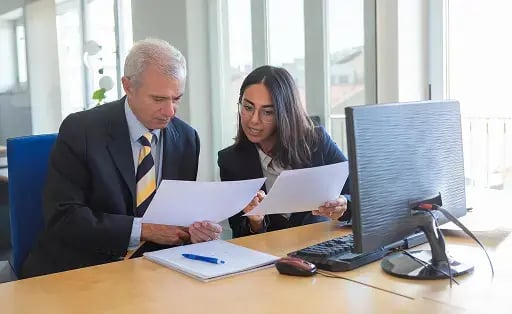 contract risk management professionals reviewing documents