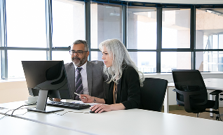 couple-focused-business-colleagues-watching-content-computer-monitor-holding-pen-mouse-business-communication-teamwork-concept 1 (1)